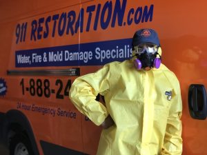 water damage restoration truck with hazmat suit employee west houston